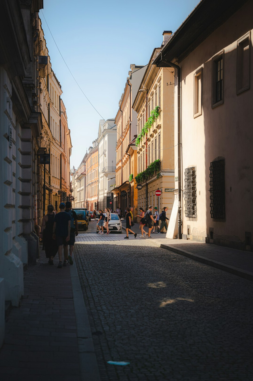 Busy European city street with old buildings and pedestrians
