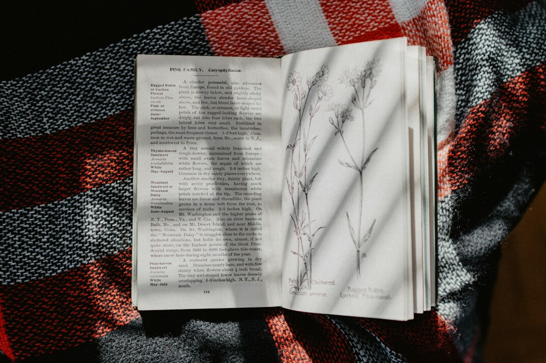 Hand writing notes in a notebook with a pen